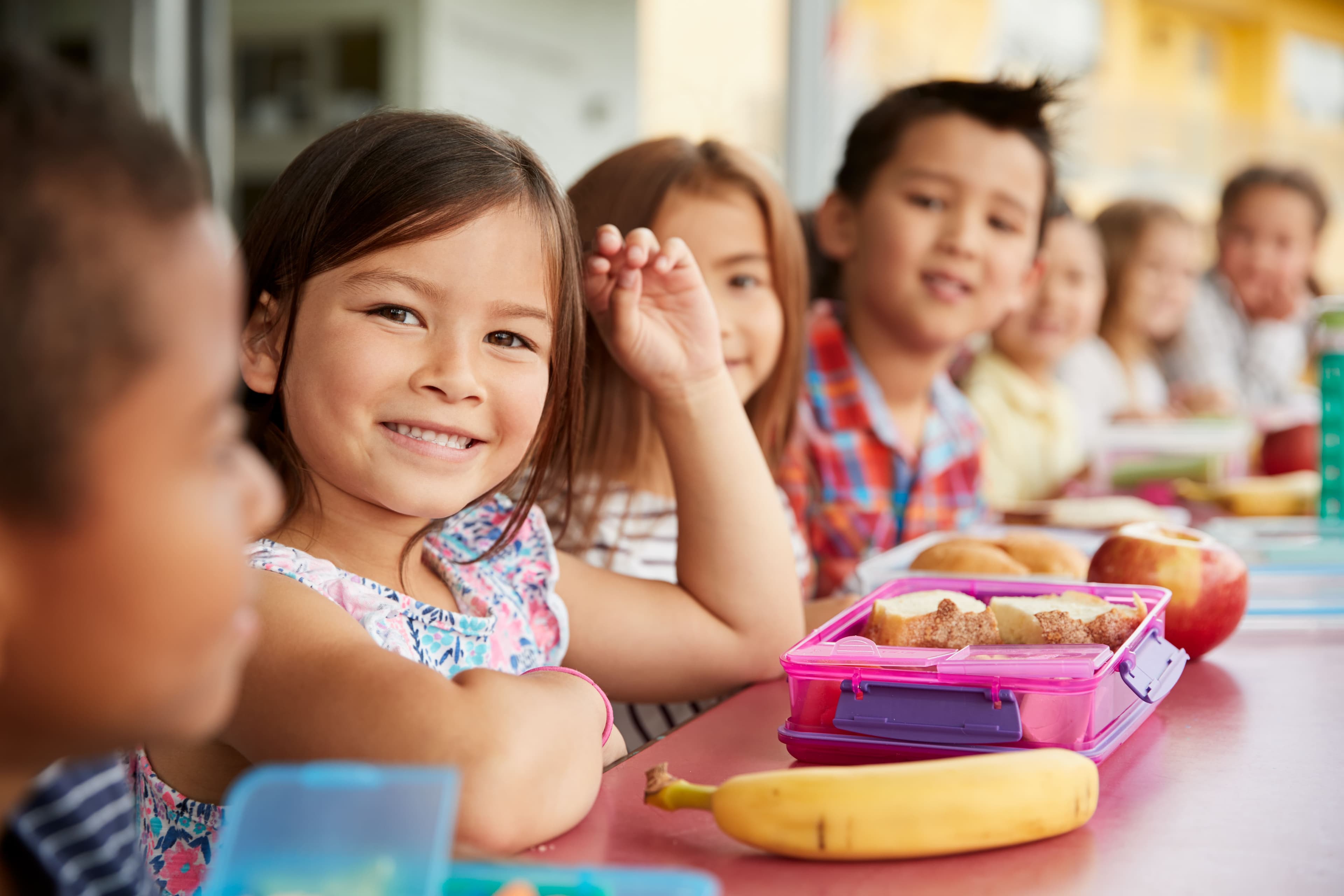 Kids sharing snacks at a school lunch table